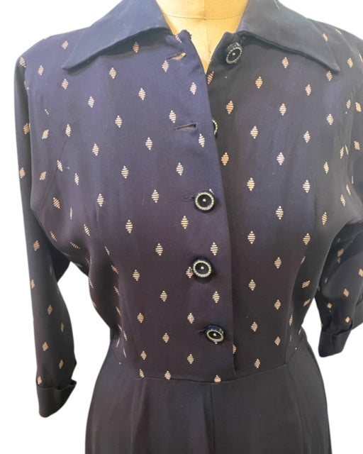 Navy blue dress with beige pattern on a mannequin against a white background