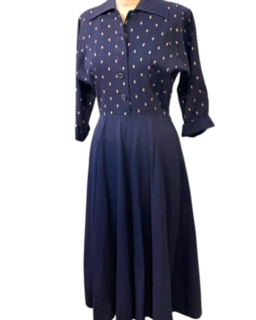 Navy blue dress with white diamond motive dots on a white background